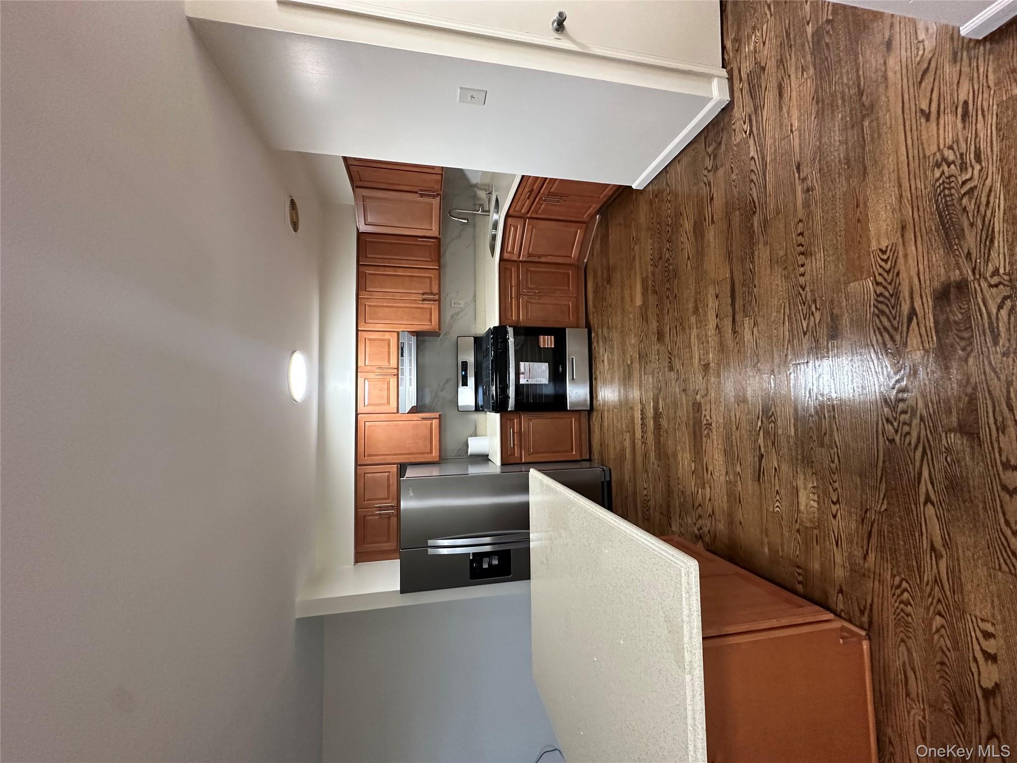987 Lincoln Avenue, Unit 2 Brooklyn, NY 11208 - Photo 2 of 7 a view of kitchen with microwave and cabinets