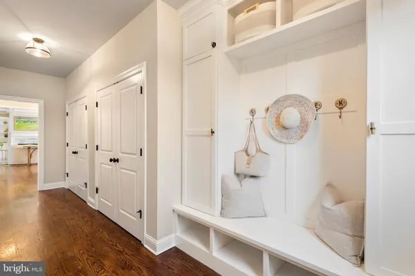 a view of a hallway with wooden floor and front door