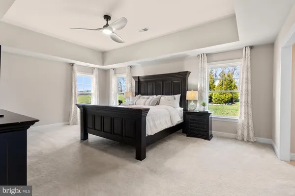 a spacious bathroom with a bathtub sink mirror and toilet