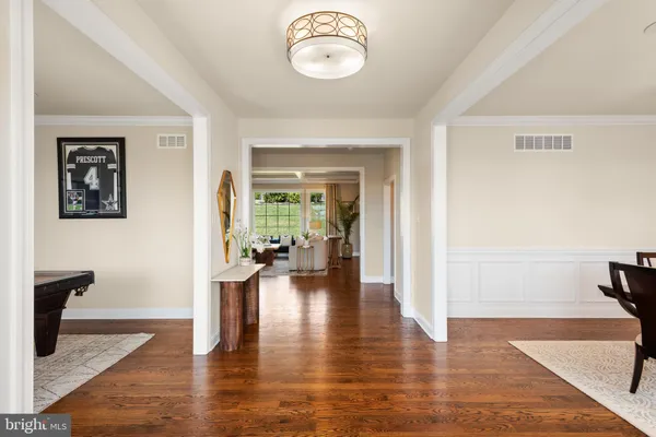 a view of a livingroom with furniture hardwood floor and a hallway