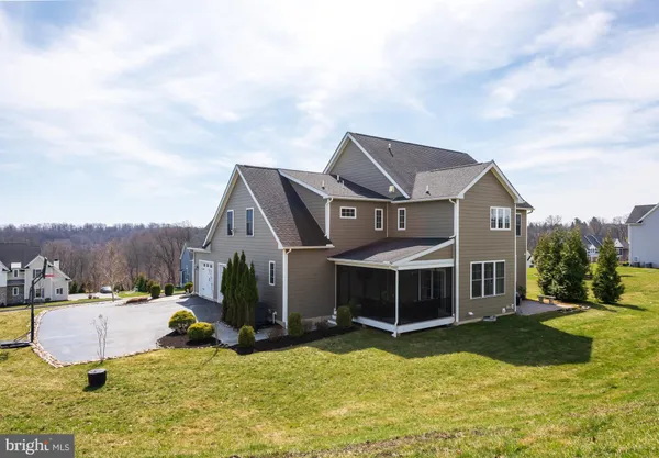 an aerial view of a house with swimming pool and a yard