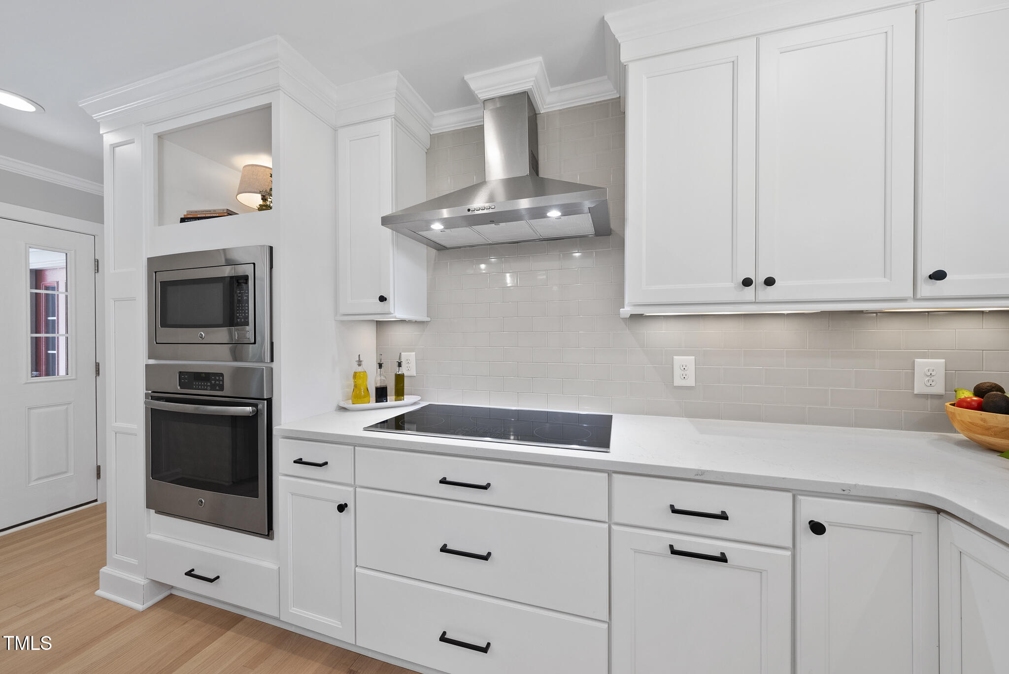 2704 Farnborough Road Raleigh, NC 27613 - Photo 16 of 39 a kitchen with stainless steel appliances white cabinets and a stove