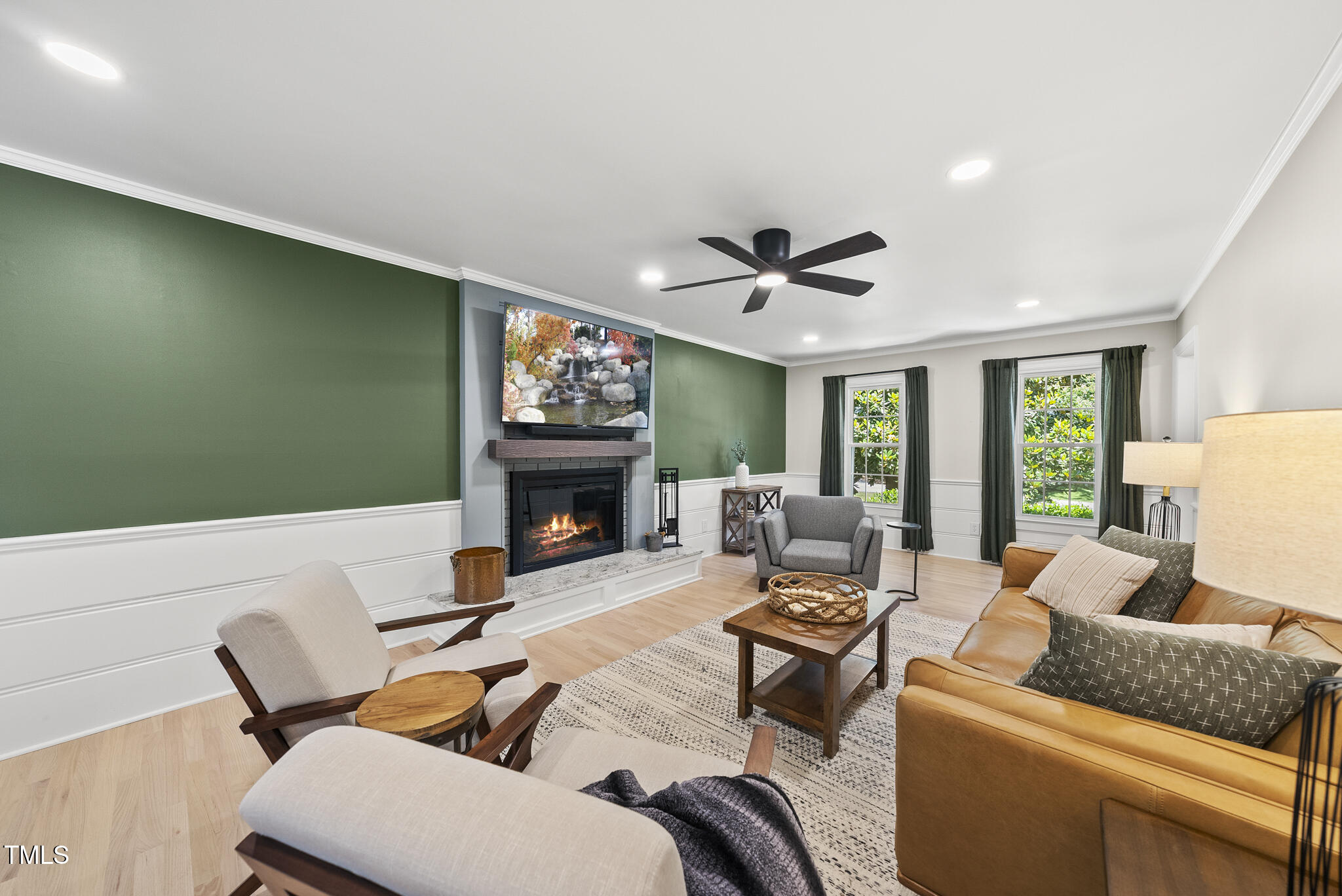 2704 Farnborough Road Raleigh, NC 27613 - Photo 17 of 39 a living room with furniture a fireplace and a large window