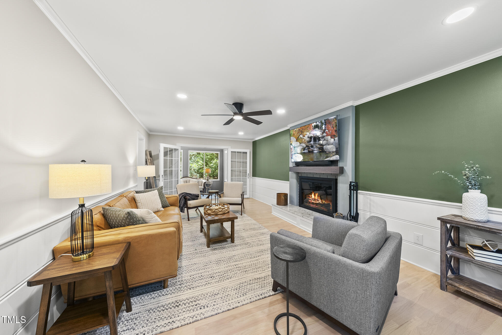 2704 Farnborough Road Raleigh, NC 27613 - Photo 20 of 39 a living room with furniture a fireplace and a flat screen tv