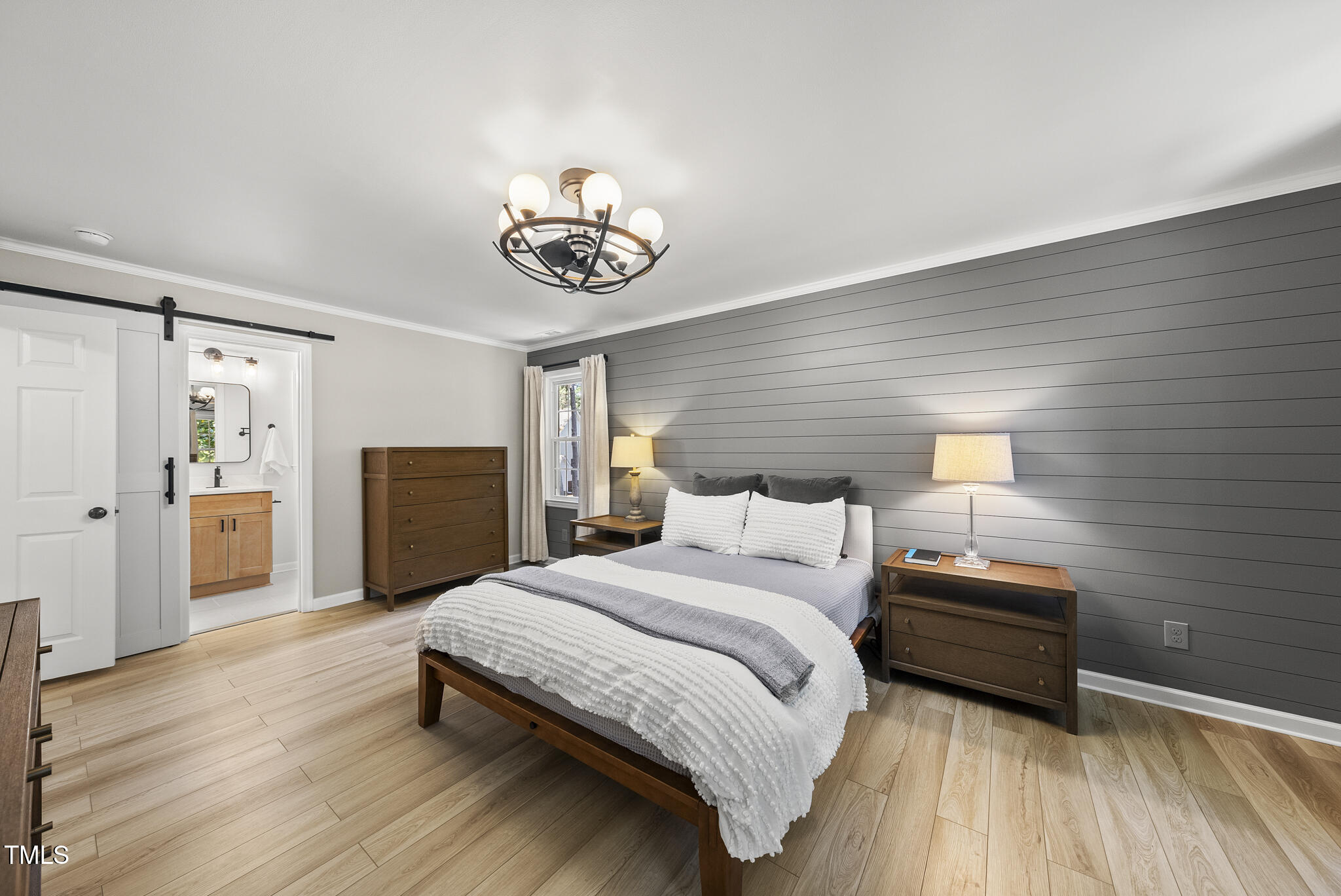 2704 Farnborough Road Raleigh, NC 27613 - Photo 22 of 39 a bedroom with a bed and a chandelier