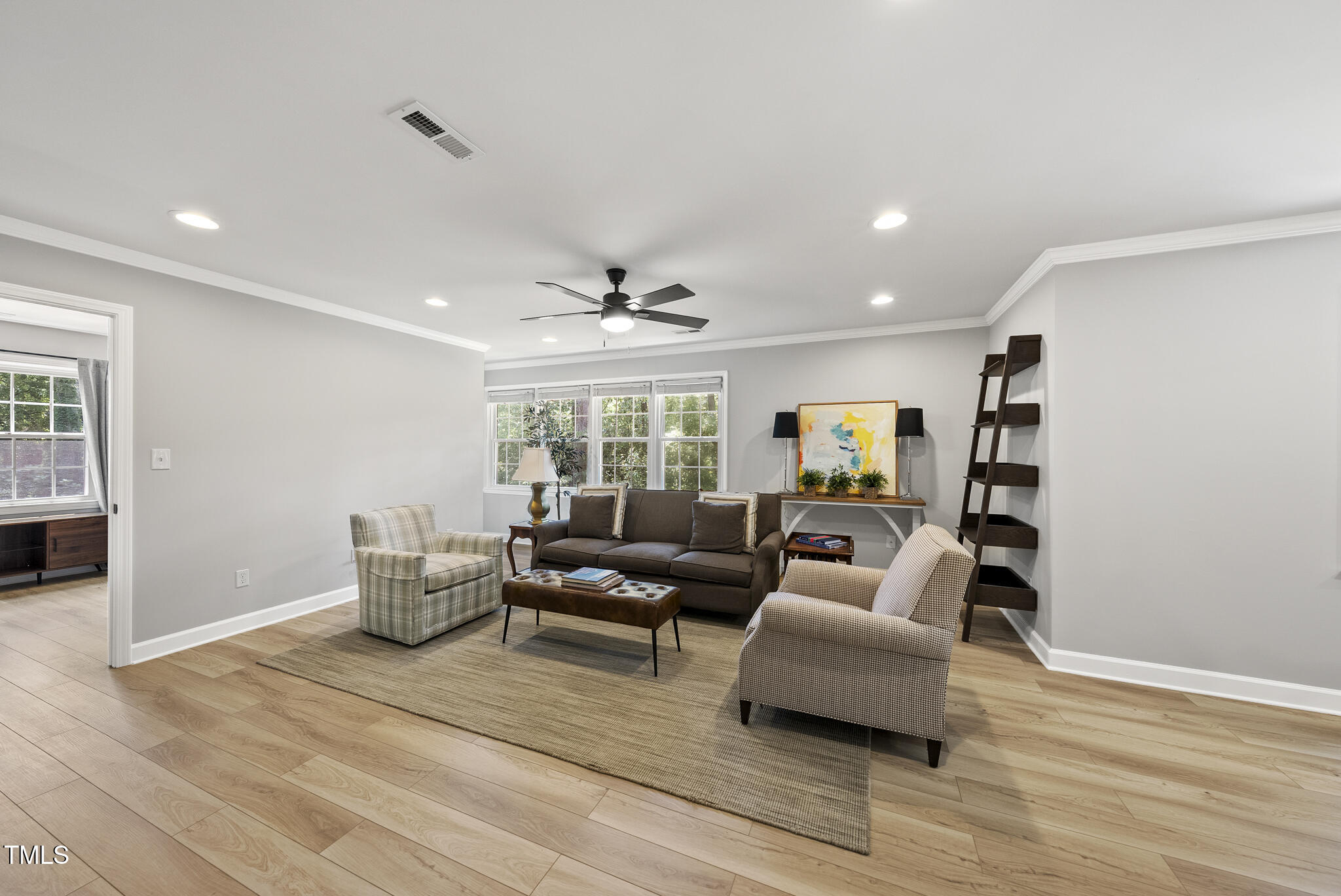2704 Farnborough Road Raleigh, NC 27613 - Photo 27 of 39 a living room with furniture and wooden floor