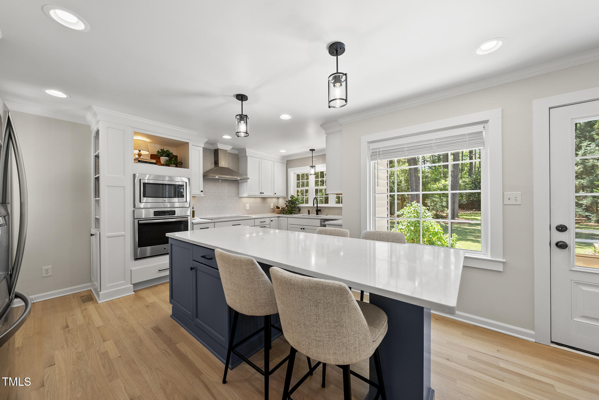 2704 Farnborough Road Raleigh, NC 27613 - Photo 3 of 39 a large kitchen with kitchen island a large island in it