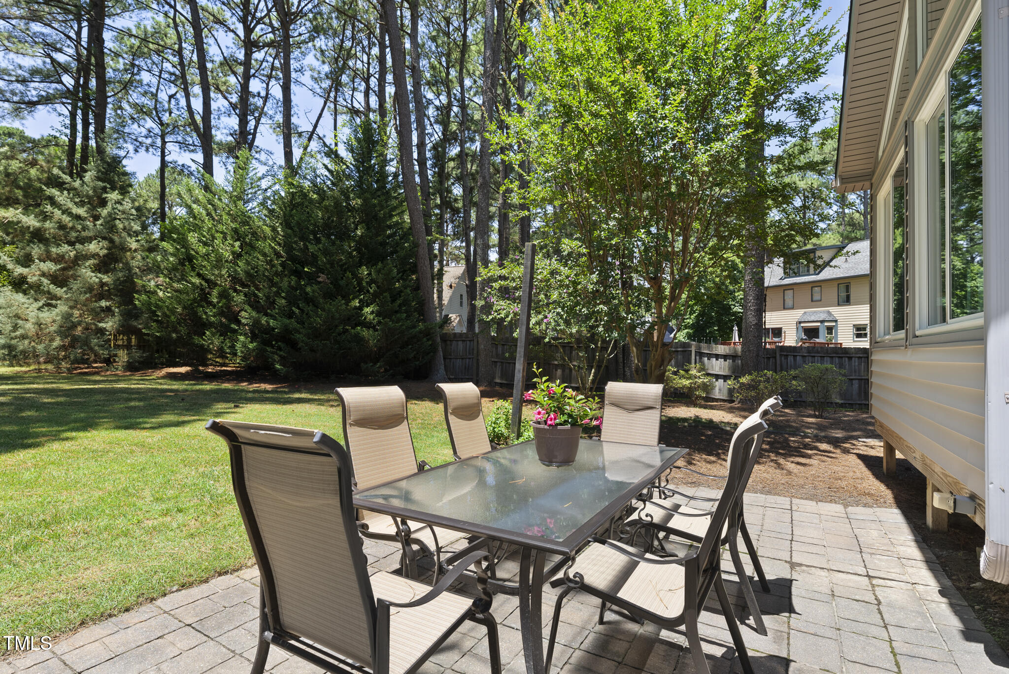 2704 Farnborough Road Raleigh, NC 27613 - Photo 33 of 39 a view of a patio with dining table and chairs with wooden floor and fence
