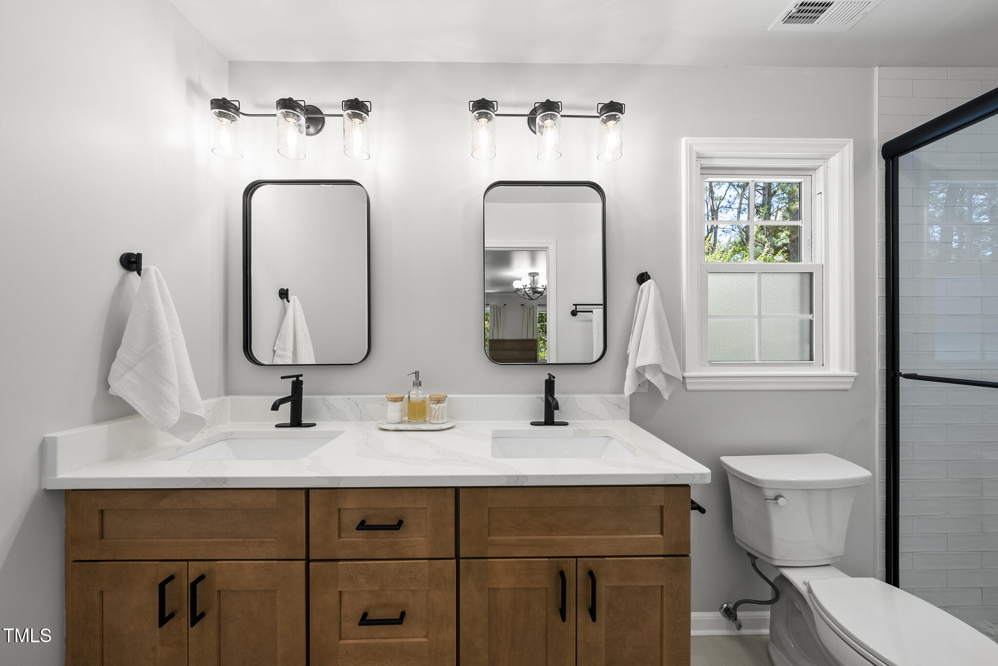 2704 Farnborough Road Raleigh, NC 27613 - Photo 7 of 39 a bathroom with double vanity sinks and a mirror
