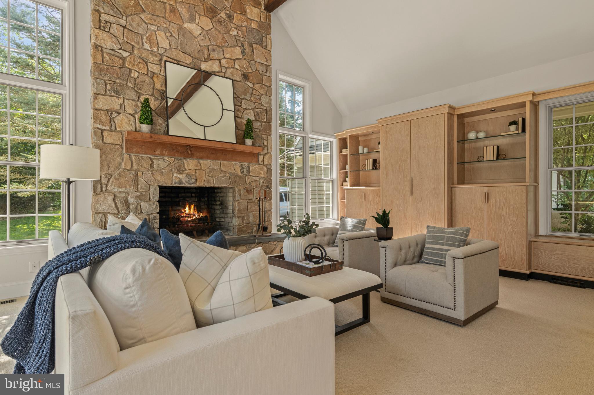 1285 Farm Road Berwyn, PA 19312 - Photo 30 of 75 a living room with furniture a fireplace and windows