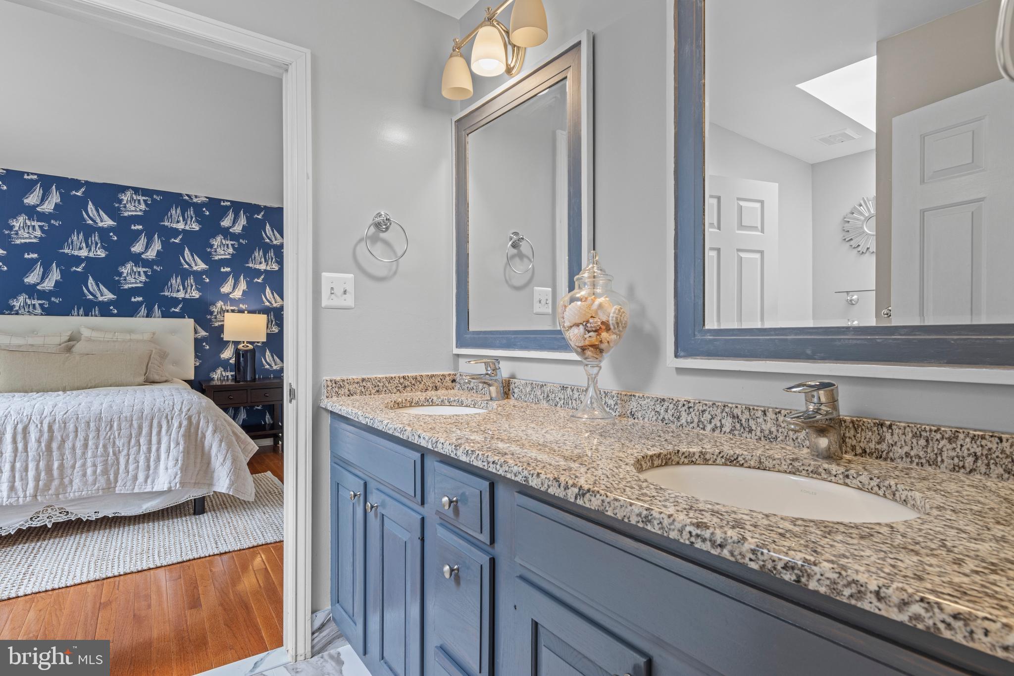 1285 Farm Road Berwyn, PA 19312 - Photo 43 of 75 a en suite bathroom with a granite countertop double vanity sink and a mirror