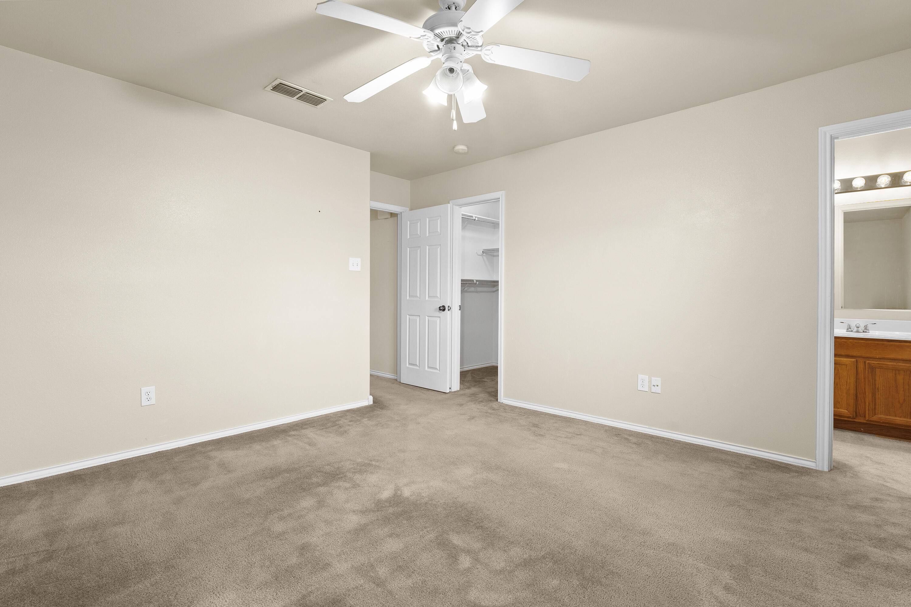 6522 93rd Street Lubbock, TX 79424 - Photo 12 of 22 an empty room with chandelier fan and closet area