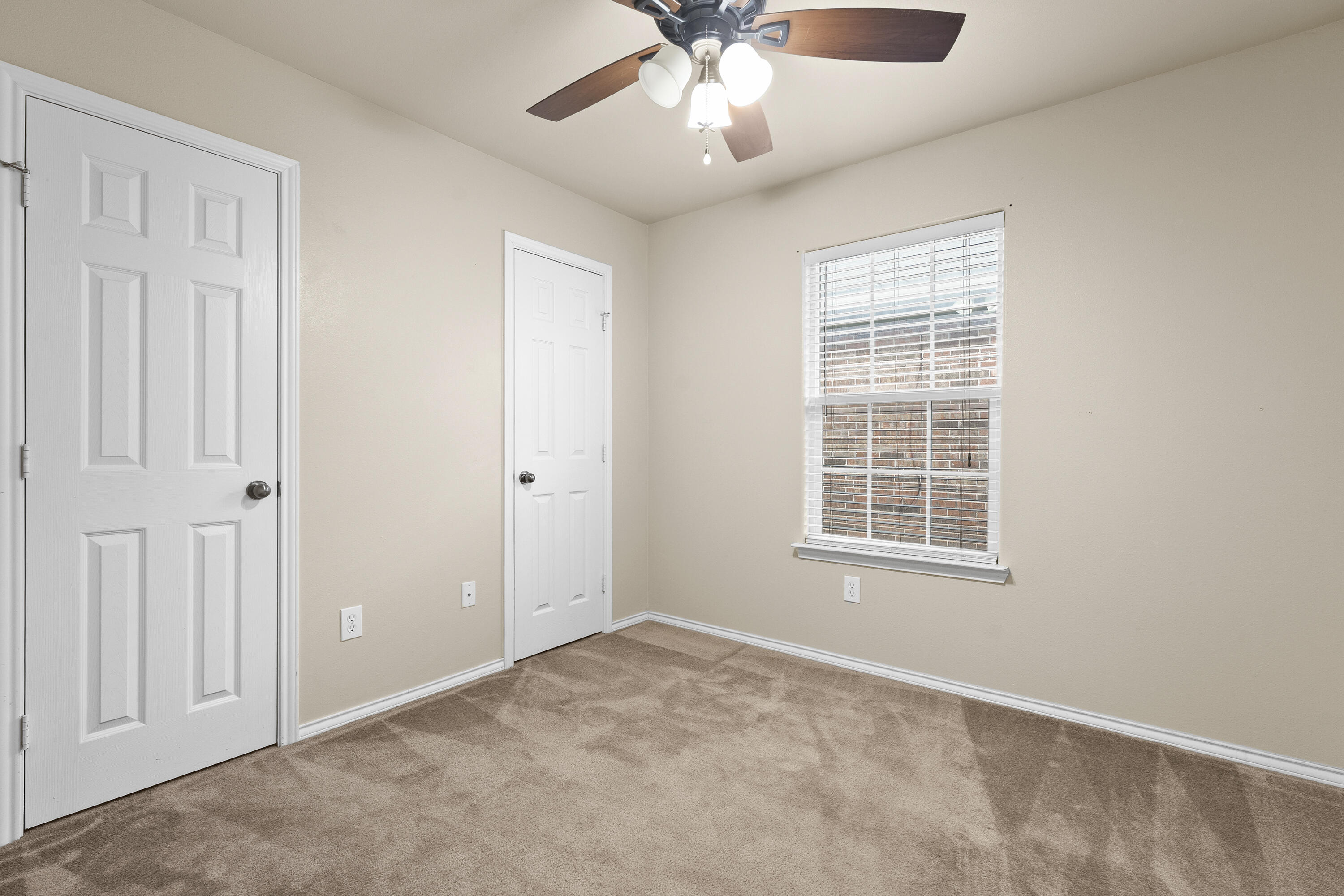6522 93rd Street Lubbock, TX 79424 - Photo 14 of 22 an empty room with chandelier fan and windows