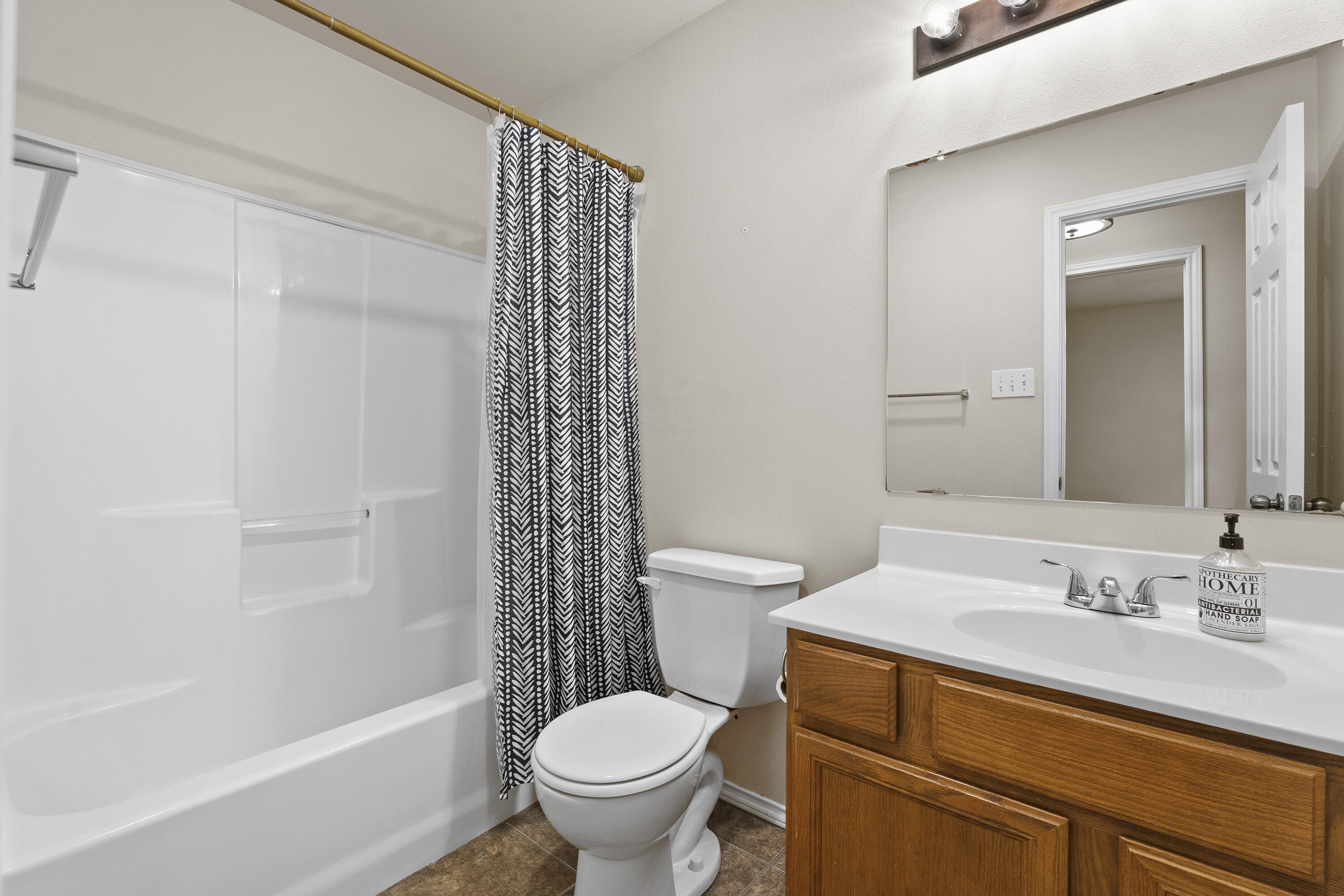 6522 93rd Street Lubbock, TX 79424 - Photo 16 of 22 a bathroom with a sink toilet and shower