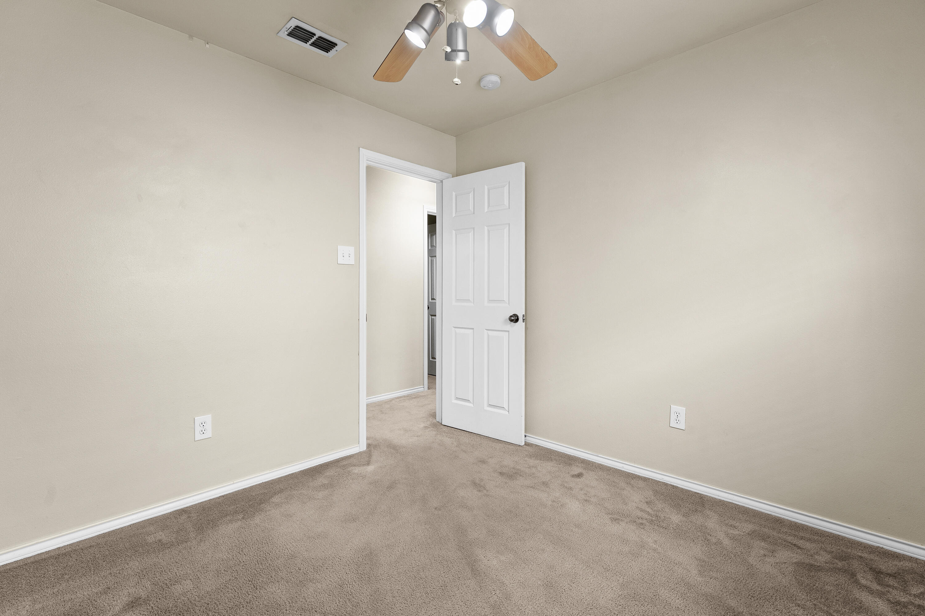 6522 93rd Street Lubbock, TX 79424 - Photo 18 of 22 an empty room with a chandelier fan and closet