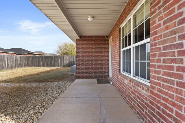 a view of a brick house with a large window
