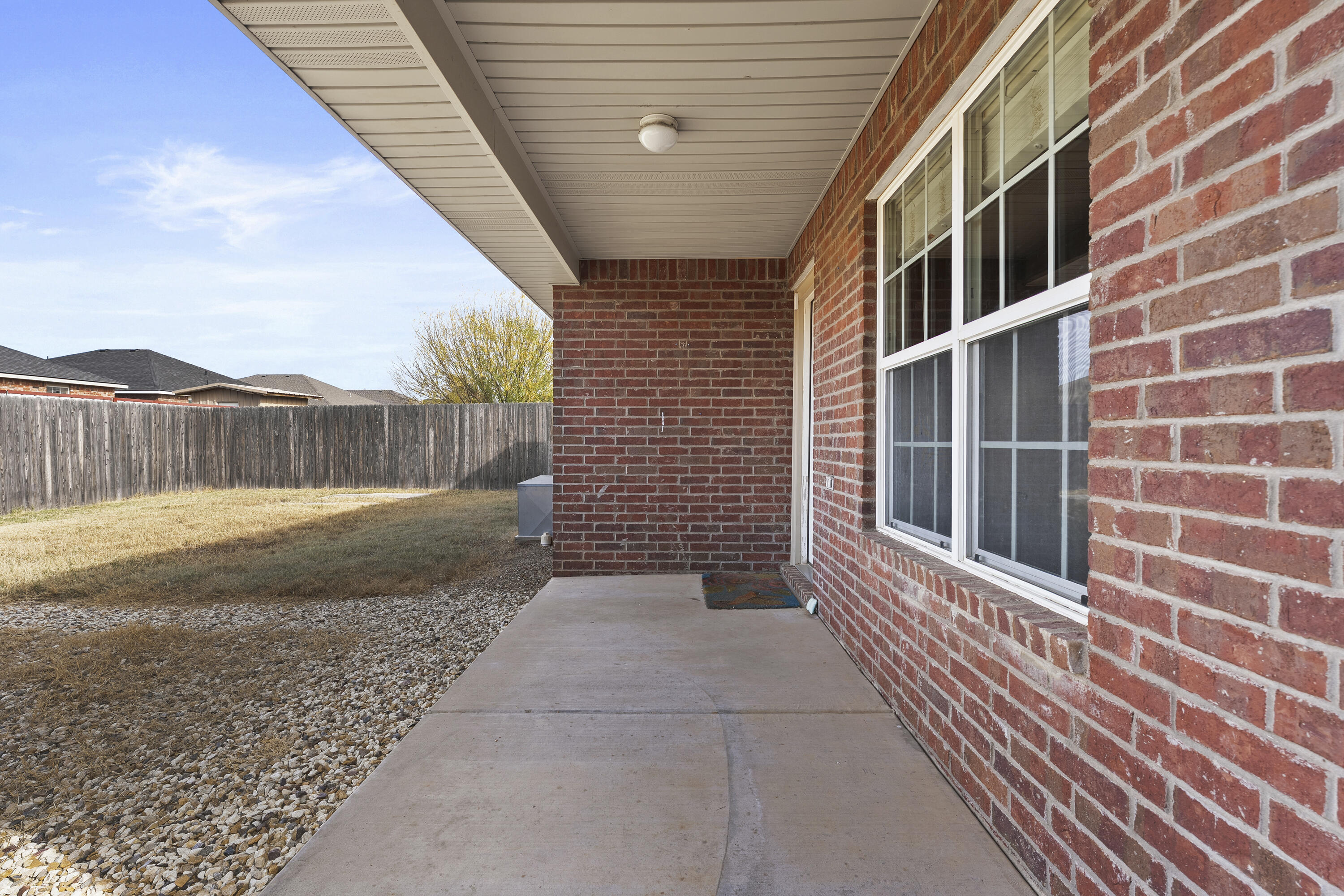 6522 93rd Street Lubbock, TX 79424 - Photo 21 of 22 a view of a brick house with a large window