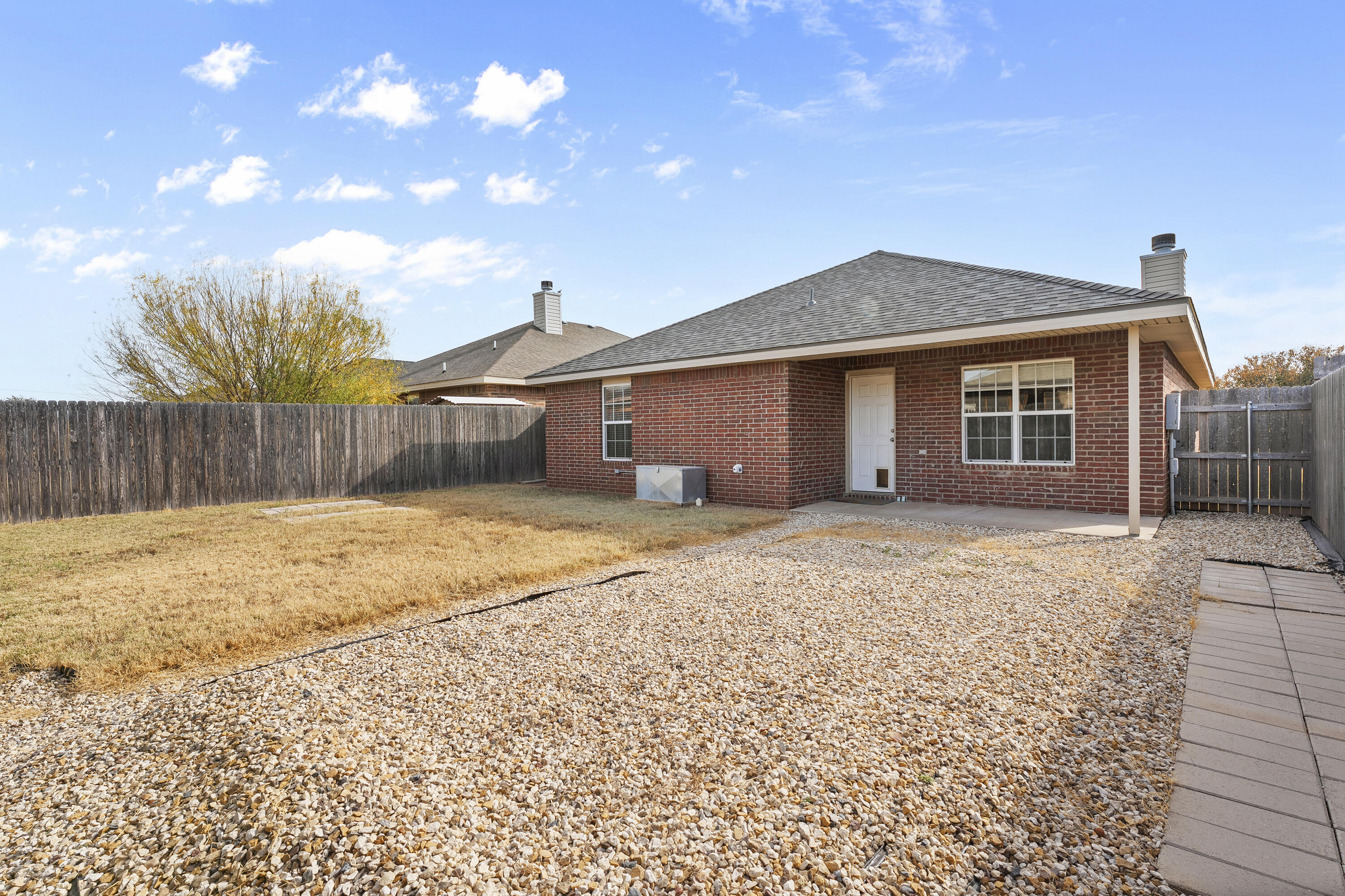 6522 93rd Street Lubbock, TX 79424 - Photo 22 of 22 a front view of a house with a yard