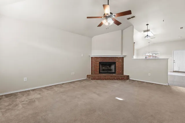 a view of an empty room with a fireplace