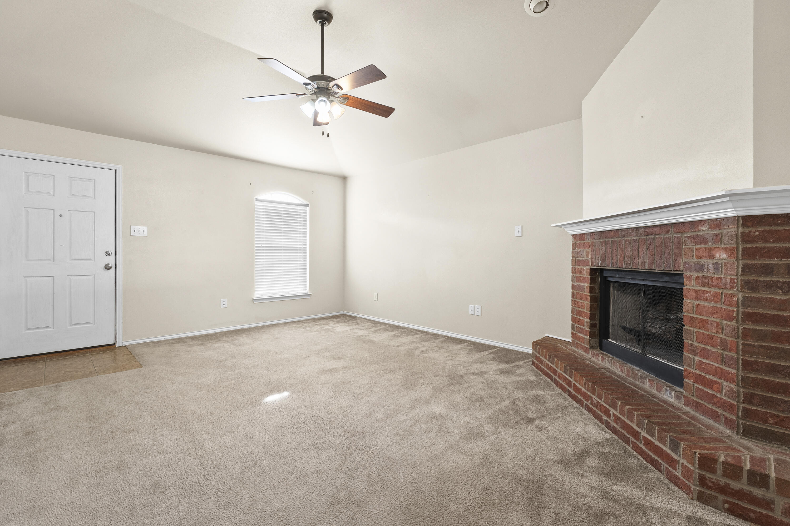 6522 93rd Street Lubbock, TX 79424 - Photo 6 of 22 an empty room with windows and fireplace