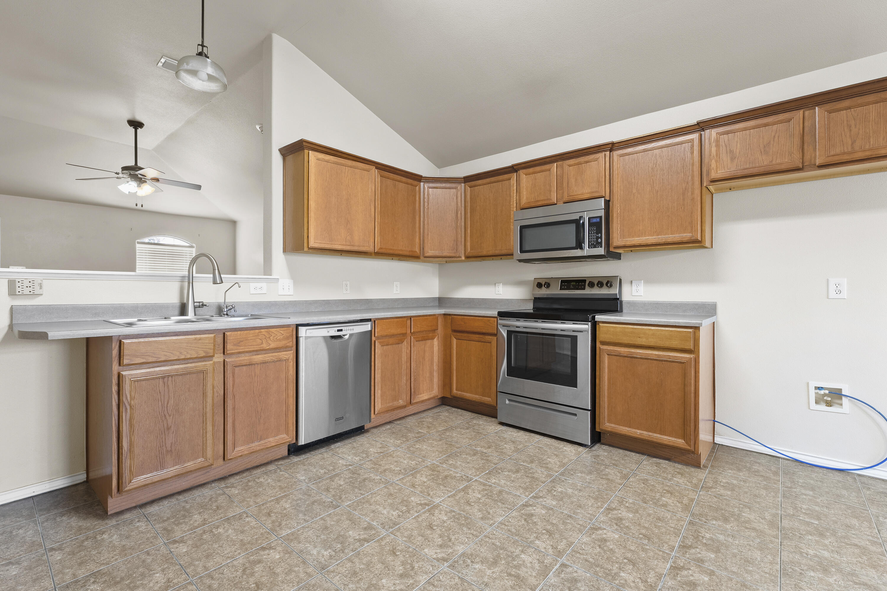 6522 93rd Street Lubbock, TX 79424 - Photo 8 of 22 a kitchen with cabinets stainless steel appliances and a sink