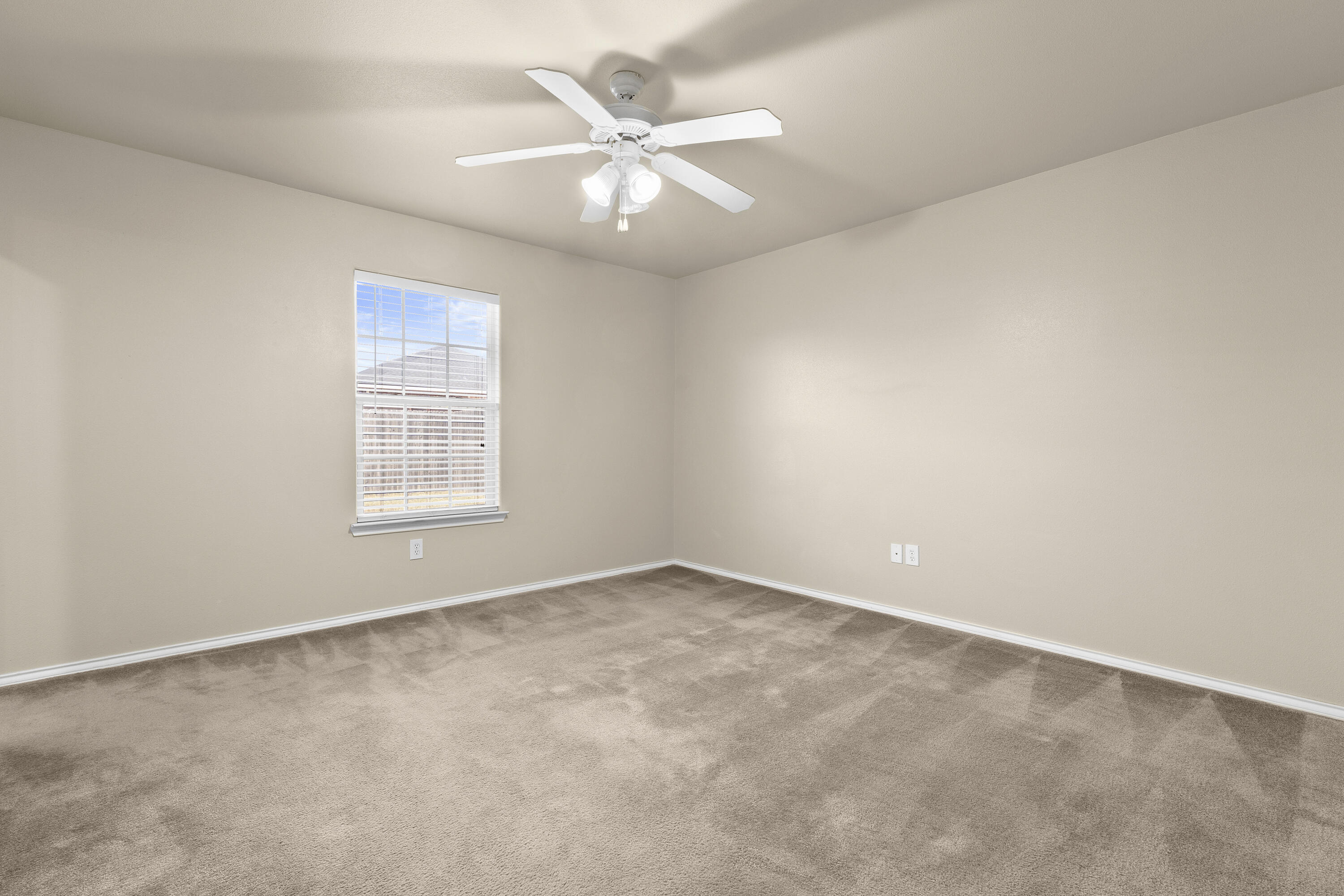 6522 93rd Street Lubbock, TX 79424 - Photo 10 of 22 an empty room with windows and fan