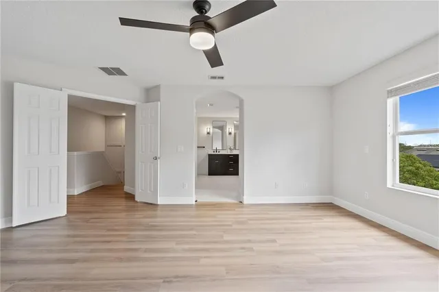 wooden floor in an empty room with a window