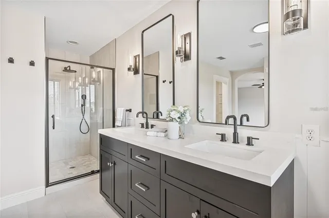 a bathroom with a double vanity sink mirror double and shower