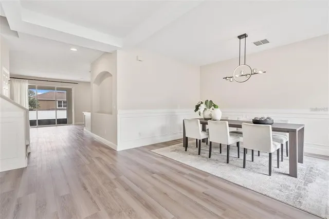 a view of a dining room with furniture wooden floor and chandelier