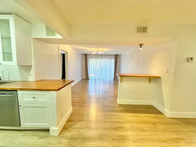 a bathroom with a granite countertop sink and a large mirror