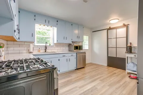 a kitchen with a stove a sink and a refrigerator