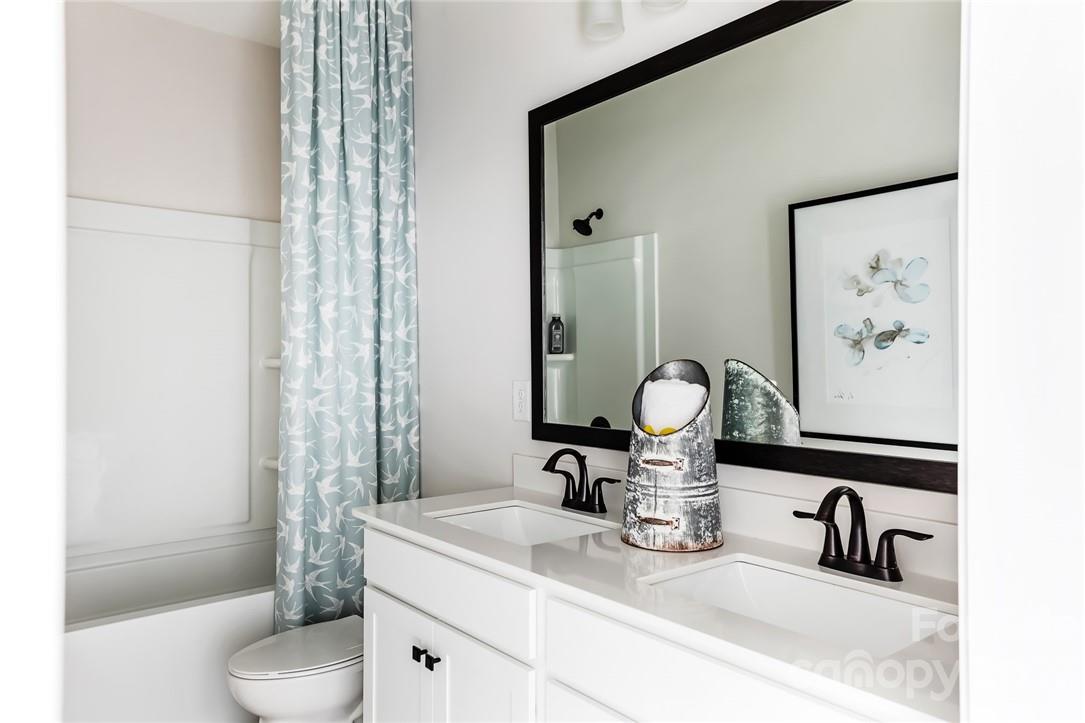 216 Brooks Springs Drive Fort Mill, SC 29708 - Photo 21 of 24 a bathroom with a toilet sink and mirror