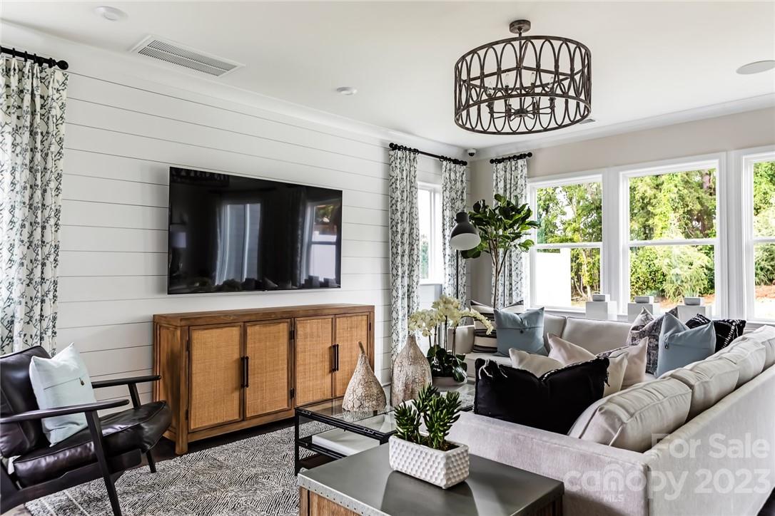 216 Brooks Springs Drive Fort Mill, SC 29708 - Photo 4 of 24 a living room with furniture a window and a chandelier