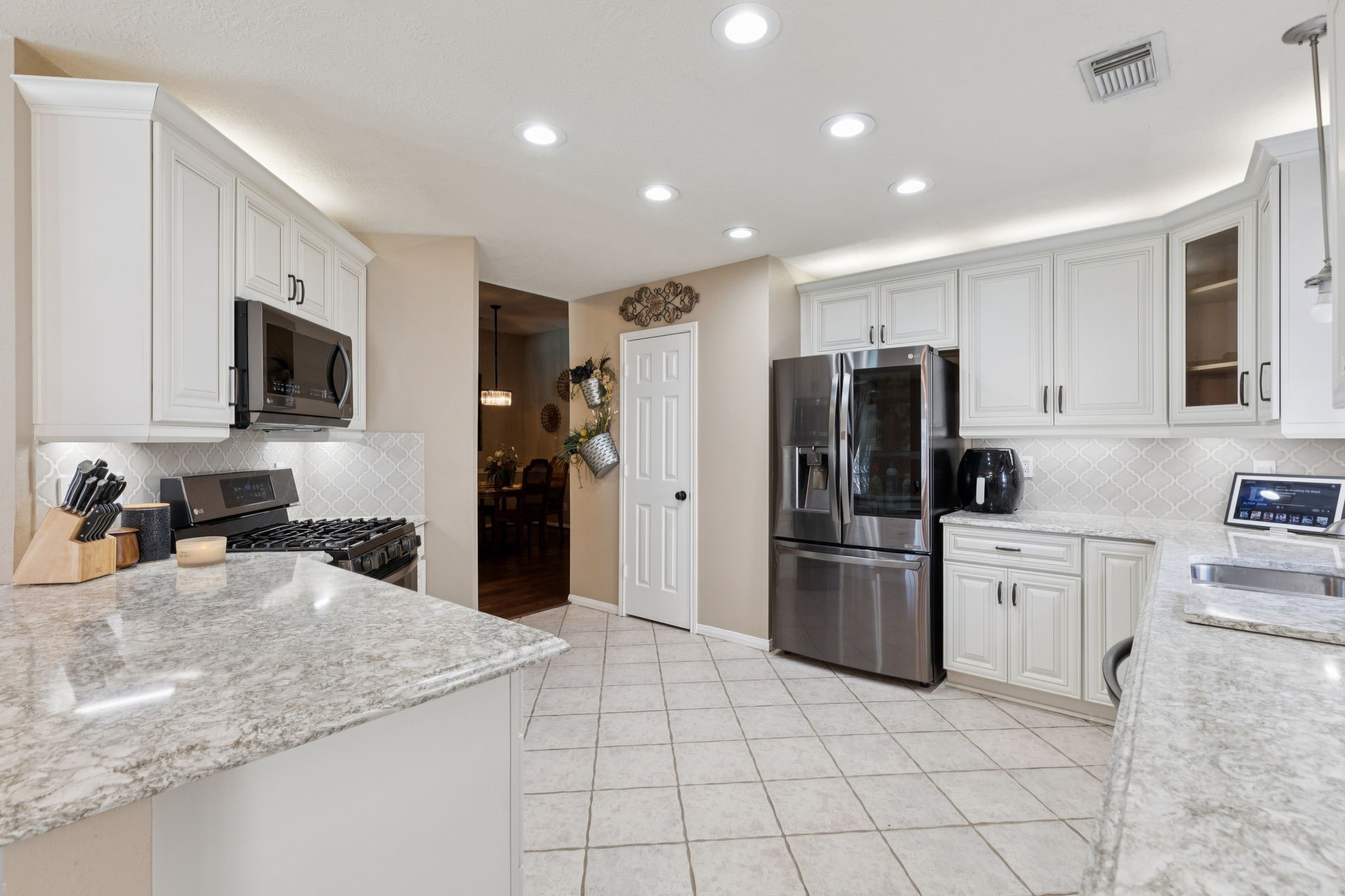 16322 Mango Ridge Court Humble, TX 77396 - Photo 11 of 20 a kitchen with stainless steel appliances granite countertop a refrigerator sink and stove