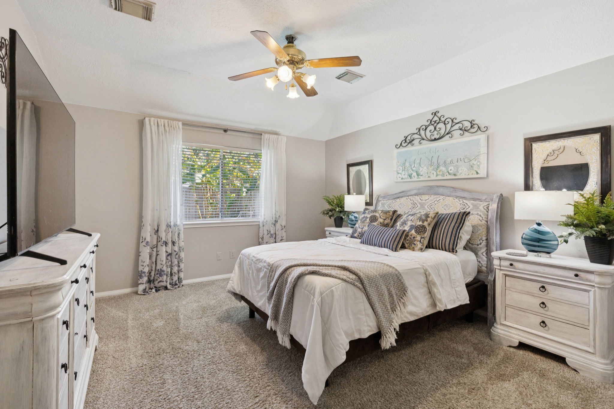 16322 Mango Ridge Court Humble, TX 77396 - Photo 4 of 20 a bedroom with a large bed and a chandelier