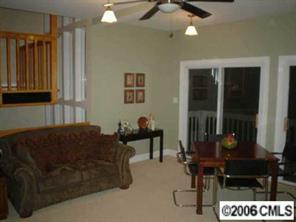 25024 Riley Lane Tega Cay, SC 29708 - Photo 6 of 8 a living room with furniture a lamp and a window