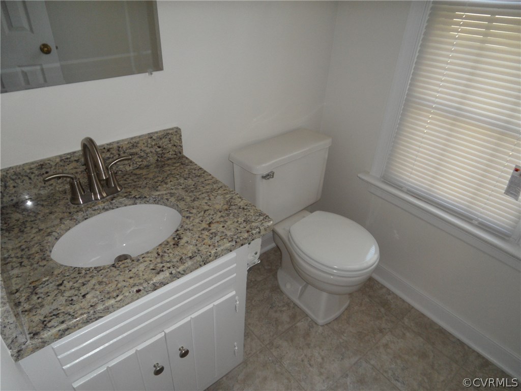 702 Fennimore Road Midlothian, VA 23114 - Photo 24 of 26 a bathroom with a granite countertop sink a toilet and a mirror