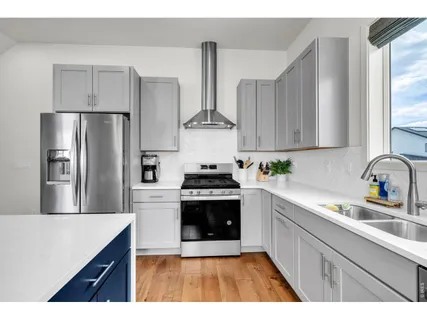 a kitchen with stainless steel appliances a stove a sink and a refrigerator