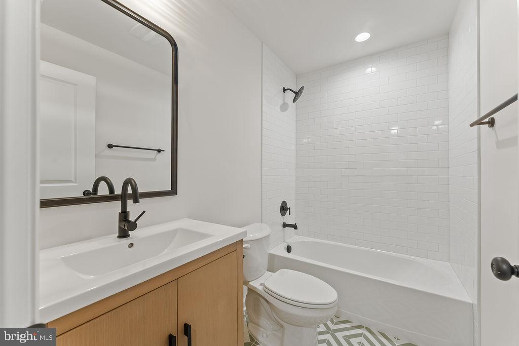 1339 Moody Town Road Bumpass, VA 23024 - Photo 33 of 63 a bathroom with a sink toilet a mirror and shower