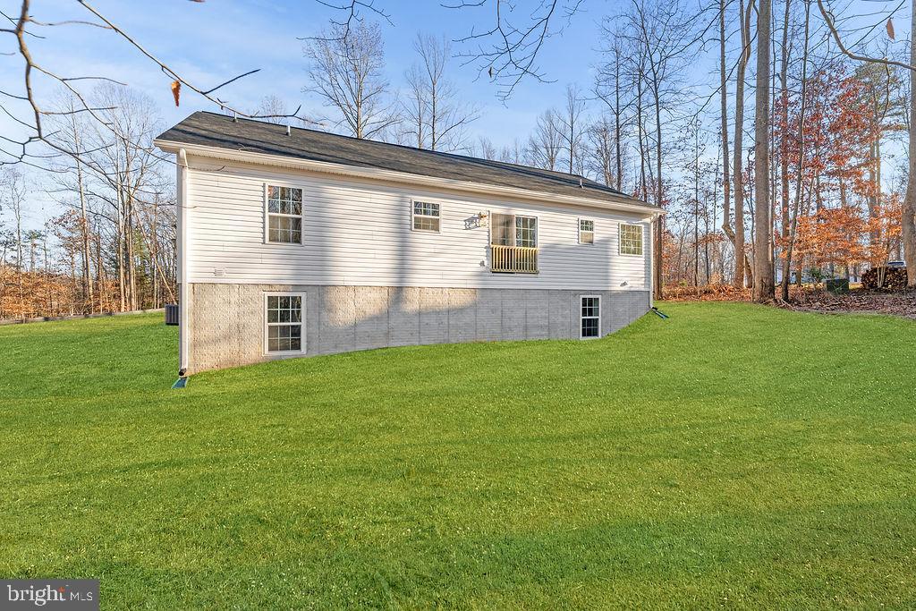 1339 Moody Town Road Bumpass, VA 23024 - Photo 62 of 63 a front view of house with yard and trees in the background