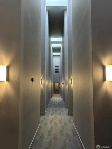 a view of a hallway with wooden shelves