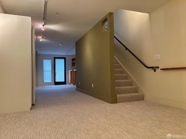 a view of a street with house in the background