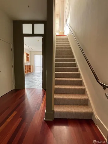 a view of entryway and hall with wooden floor