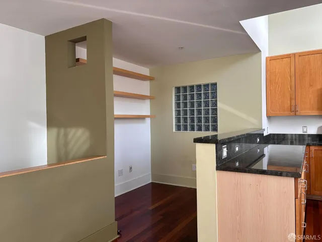 a kitchen with granite countertop cabinets and chairs