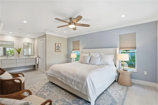 a bedroom with a bed and ceiling fan