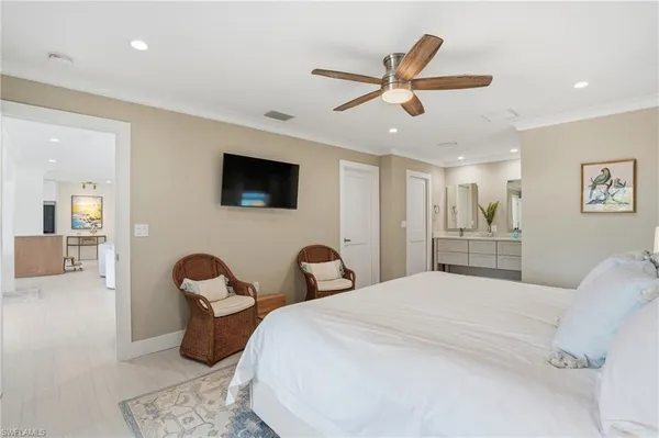 a bedroom with a large bed and a chandelier