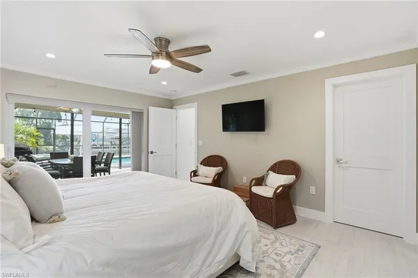 a bedroom with a bed and large window