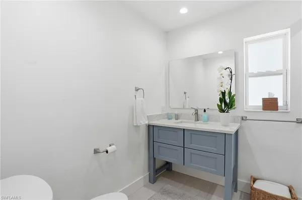 a bathroom with a sink toilet and mirror