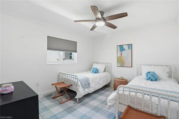 a bedroom with two beds and a window