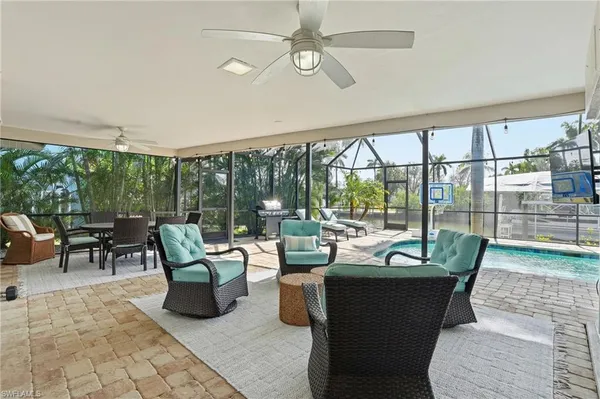 a living room with furniture and a floor to ceiling window